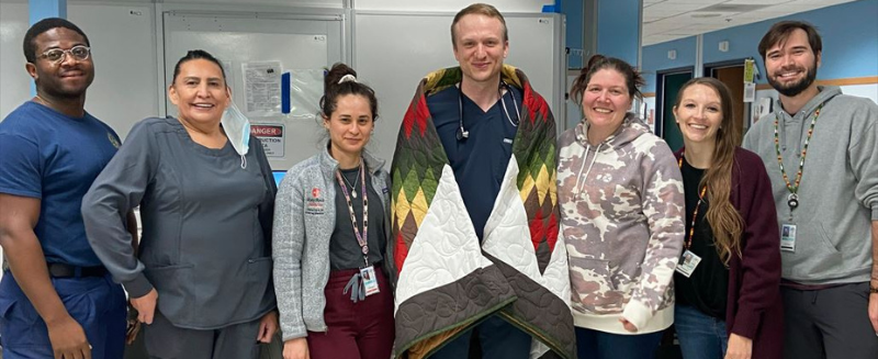 Dr. Laura Romcevich, Dr. Bradley Parke, Dr. Madison Bangert, Dr. Diana Lenis - honoring Dr. Modic with a traditional Star Quilt