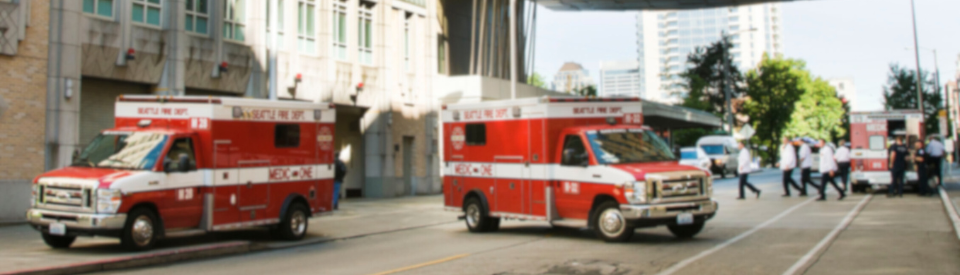 Photo of two ambulances in the street outside of Harborview Medical Center