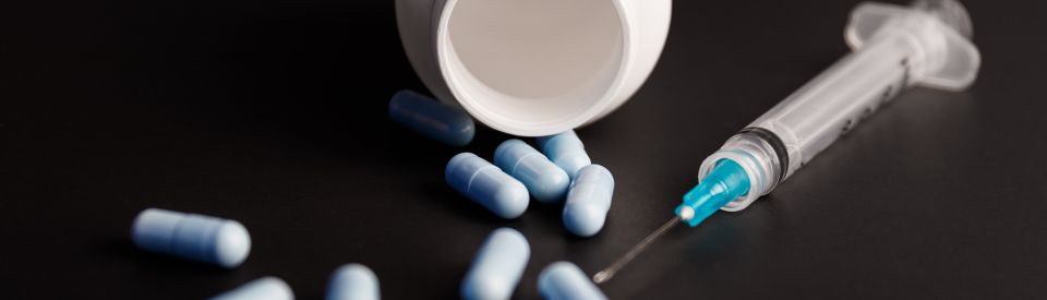 Stock photo of pills and a syringe 