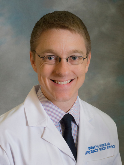 Headshot of Dr. Andrew Latimer in a white coat against a gray background