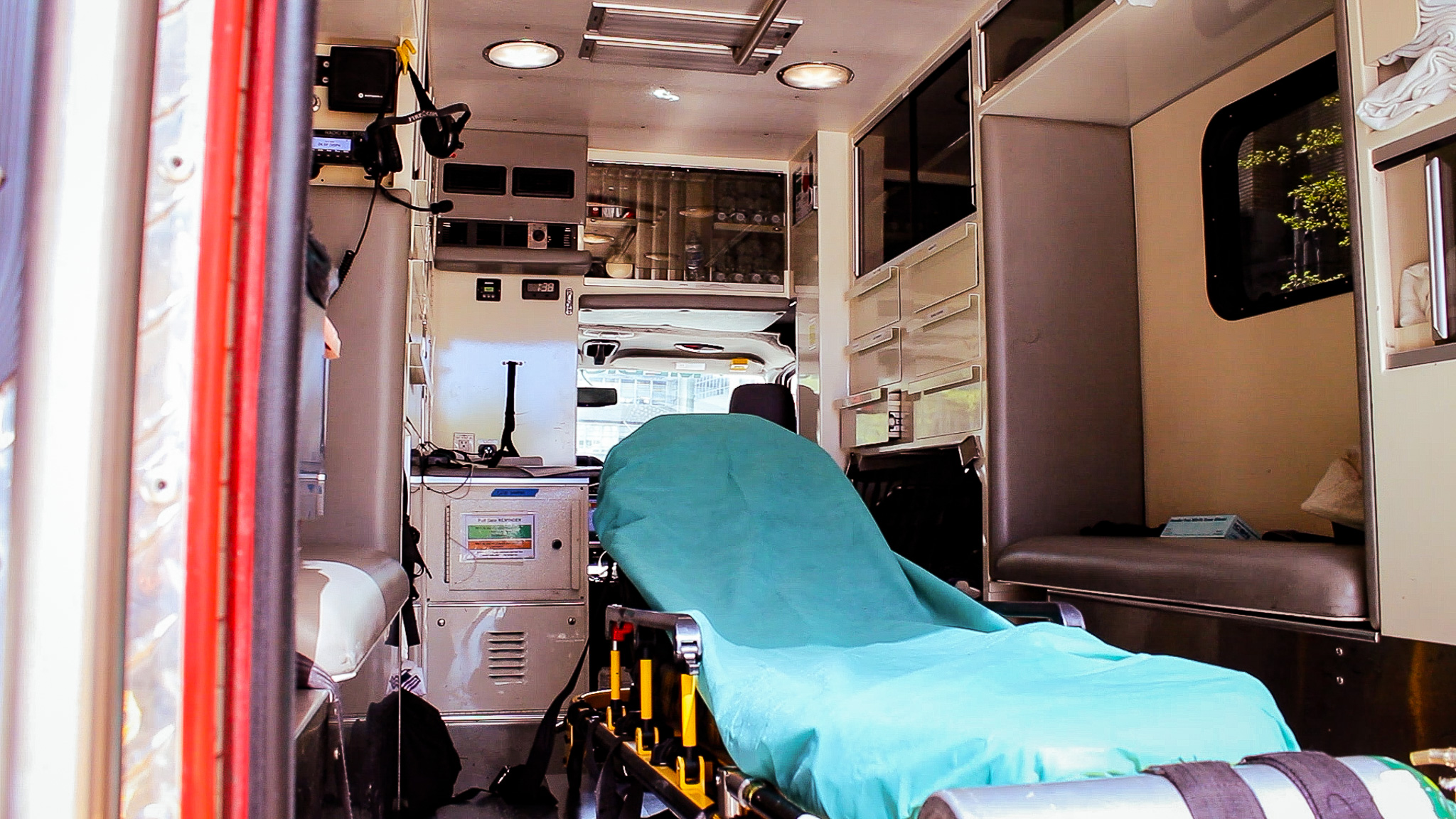 A stretcher sits inside the inside of the Health 99 ambulance.