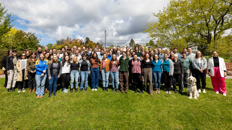 A group picture of the residents outside on the grass.