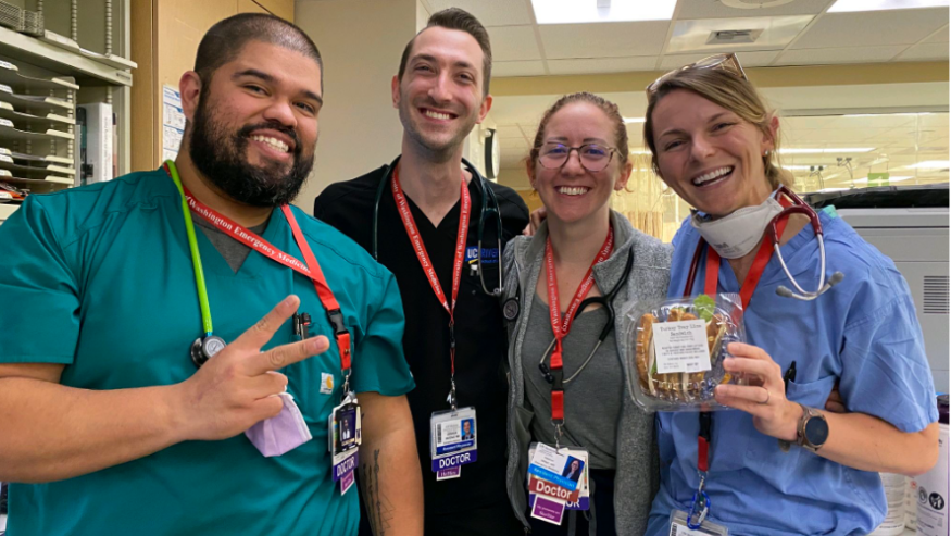A group of four residents pose for a picture inside the emergency department.