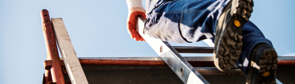 A man climbs on a ladder.