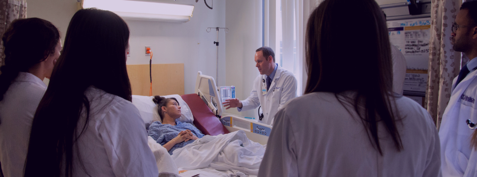 Dr. Ilgen assess a patient while teaching trainees.