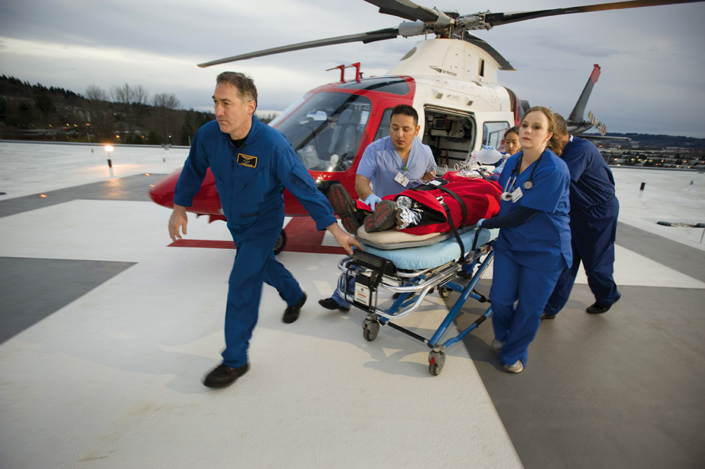 Airlift NW Nurses bringing patient off the helicopter on chopper