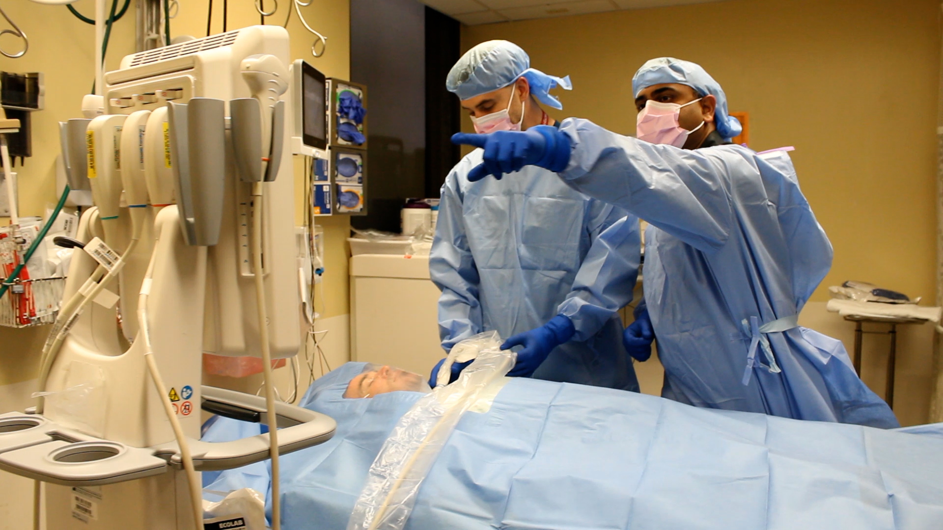 Dr. Vasisht Srinivasan walks resident Ian Benjamin through a procedure