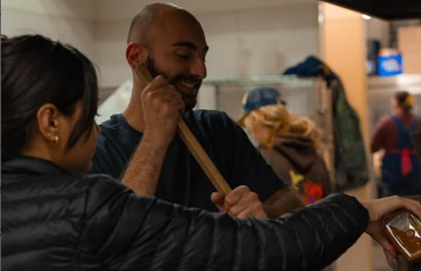 Naeem Bayaa, former resident, helps stir a pot at Operation Nightwatch