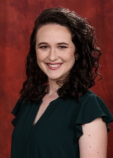 Headshot of Cristina Sanchez against a reddish-orange background