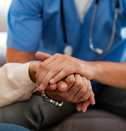 A doctor holding a paitents hand