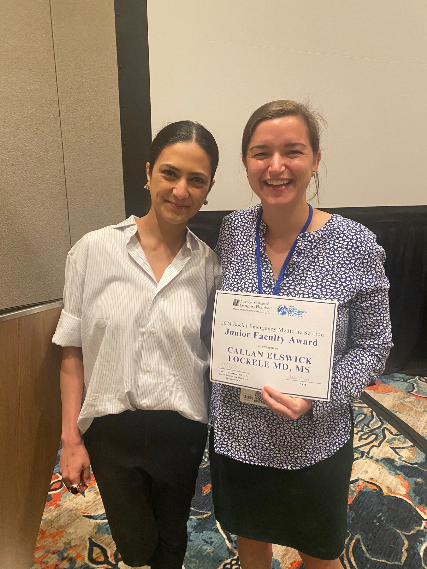 Dr. Fockele stands holding her award from ACEP