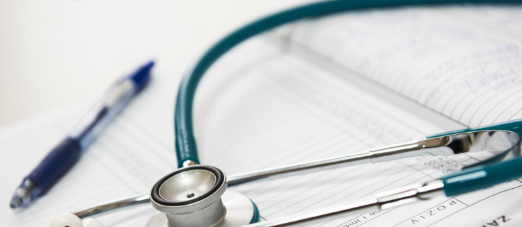 Stock photo of a stethoscope and a pen and doctors notes