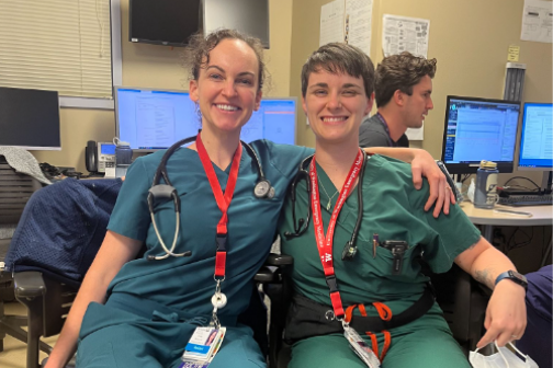 Two residents pose for photo in ER