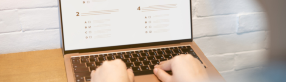 A person takes an online test on their laptop.