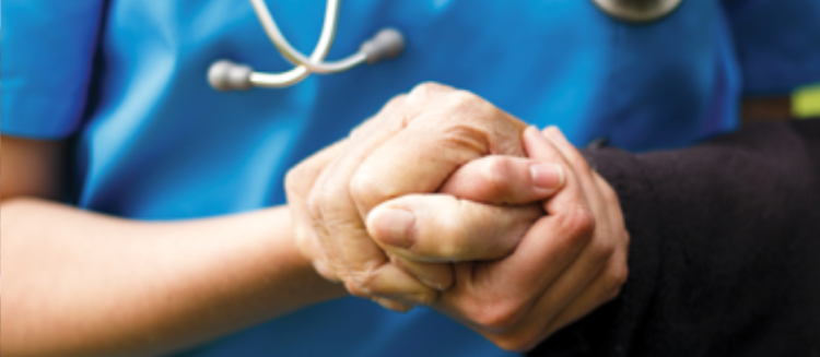 A doctor holds the hand of a patient.