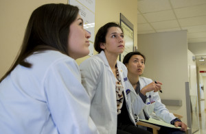 Med students sit and listen to a speaker