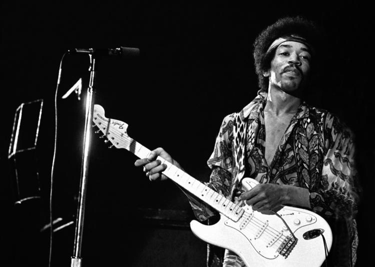 Jimi Hendrix playing guitar.
