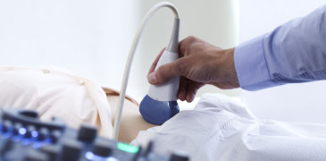 A doctor performs an ultrasound on a patient's stomach