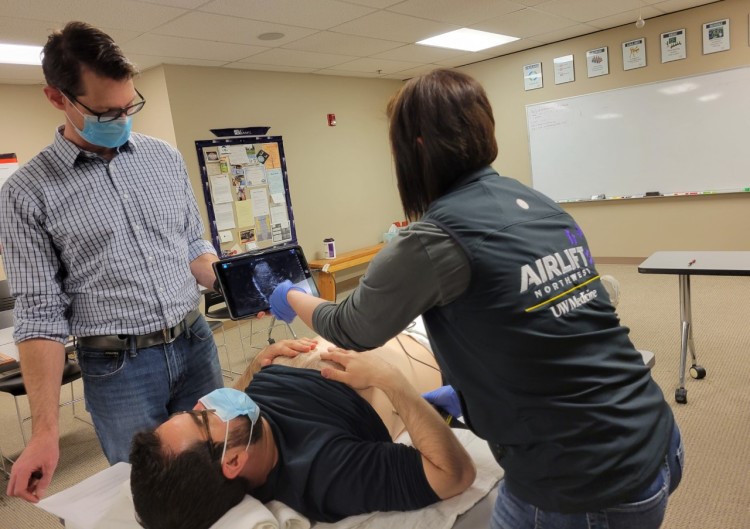 UW personnel perform an ultrasound during a training.